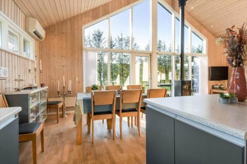 a kitchen and dining room with a table and chairs at C11308-Tarm-Stikkelsbaervej-41 in Tarm