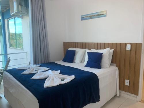 a hotel room with a bed with towels on it at Guest House Forno in Búzios