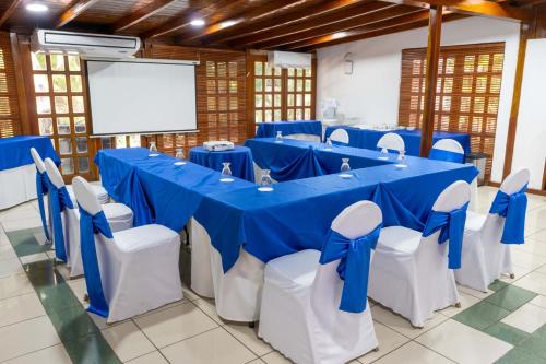 a conference room with blue and white tables and chairs at Best Western Las Mercedes Airport in Managua