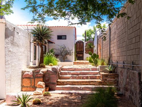 a house with stairs leading up to a building at InHouse Glamping Hotel La Paz in La Paz