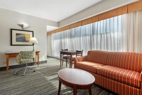 a living room with a couch and a table at Best Western Plus Suites Downtown Calgary in Calgary