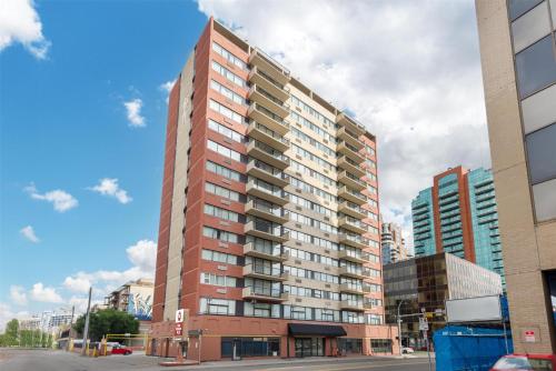 a tall red building on a city street at Best Western Plus Suites Downtown Calgary in Calgary