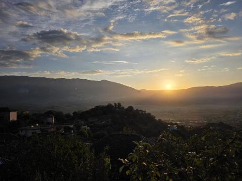 a view of the sun setting over a city at Guri Guesthouse in Gjirokastër