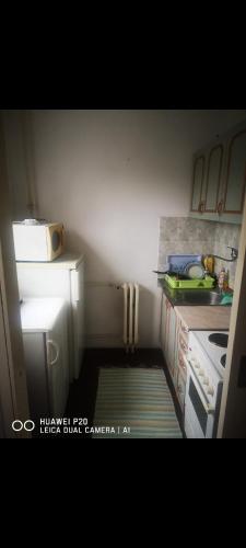 a small kitchen with a sink and a stove at Apartman Dunja in Belgrade