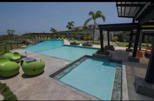a large swimming pool with a green object next to it at Casa Luna in Santa Cruz