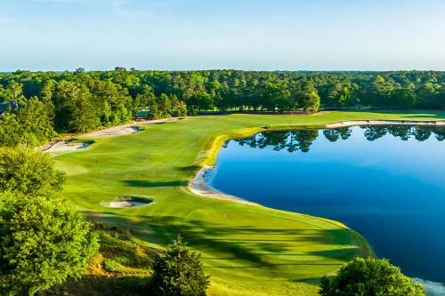 an aerial view of a golf course with a lake at Haven On The Links in Pawleys Island