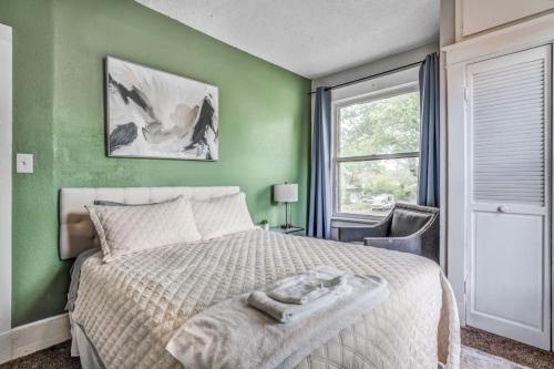 a green bedroom with a bed and a window at Chic Midtown Apartment Near Zoo, Park and Museums in Memphis