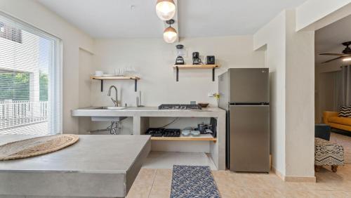 a kitchen with a sink and a refrigerator at Apt 413- Walk to the beach, plaza and restaurants in Rincon