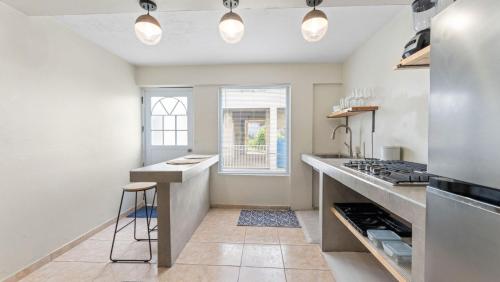 a kitchen with a counter and a stove at Apt 413- Walk to the beach, plaza and restaurants in Rincon