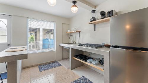 a kitchen with a sink and a stove top oven at Apt 413- Walk to the beach, plaza and restaurants in Rincon