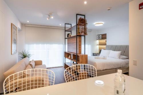 a room with a bed and a couch and chairs at La Mar by Geko in Lima