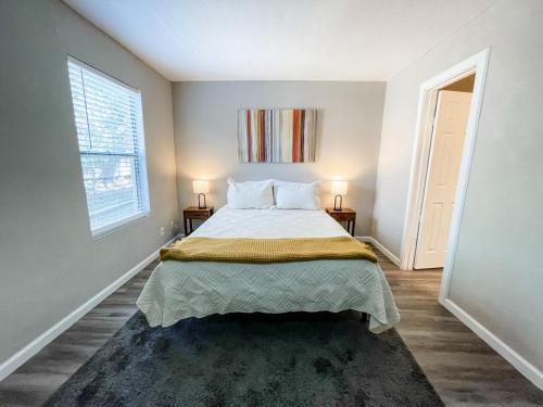 a bedroom with a bed with two night stands and a window at Perfect for Group with 2BR, 2BA and Pool in Robstown