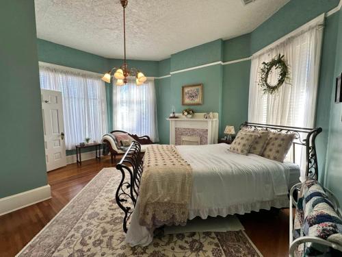 a bedroom with green walls and a bed in a room at The Redbud Room at The Judges Chambers in Guthrie