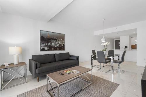 a living room with a couch and a table at Fortune House Hotel Suites in Miami