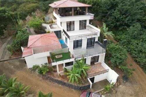 an aerial view of a house with at Coastal Villa Retreat with Private Jacuzzi and Garage Near Isla de la Plata in Puerto López