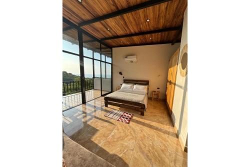 a bedroom with a bed and a balcony at Nature Escape Villa with Pools and Jacuzzis and Pet-Friendly Stay in Puerto López