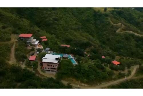 an aerial view of a house on a hill at Nature Escape Villa with Pools and Jacuzzis and Pet-Friendly Stay in Puerto López