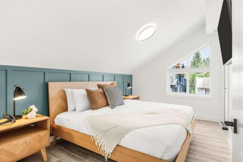 a bedroom with a large bed and a window at 3BR Escape BBQ, Balcony, Near Banff & DT in Canmore