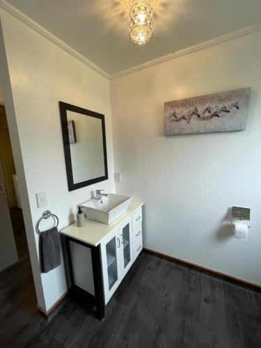 a bathroom with a sink and a mirror at Glacier Barn House in Tatare