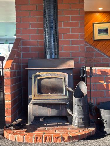 a brick oven with a pot on top of it at Glacier Barn House in Tatare