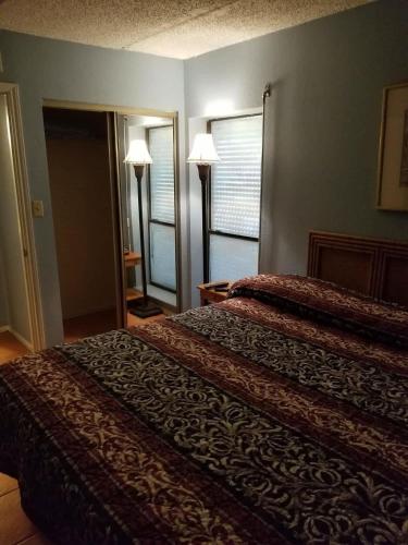 a hotel room with two beds and two lamps at Walk to Beach House in Heart of Entertainment District - Atrium unit 102 in South Padre Island