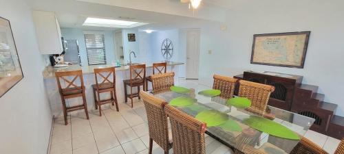 a dining room with a table and chairs and a kitchen at Saida Towers II #104 condo in South Padre Island