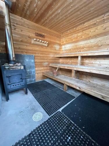an empty wooden sauna with a stove in it at Lilac Retreat Lakefront with Sauna & Pickleball in Saint Joseph