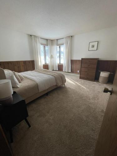 a large bedroom with a large bed and windows at Lilac Retreat Lakefront with Sauna & Pickleball in Saint Joseph