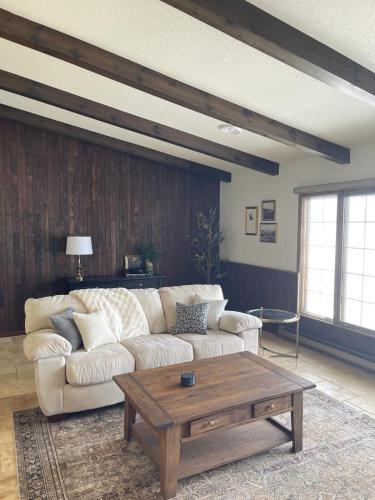 a living room with a couch and a coffee table at Lilac Retreat Lakefront with Sauna & Pickleball in Saint Joseph