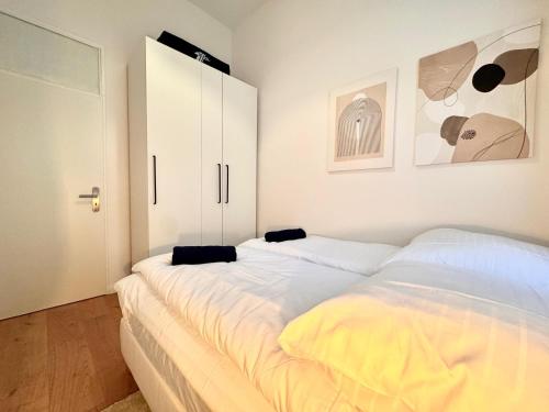 a bedroom with two beds and white cabinets at Best Spot in XBerg in Berlin