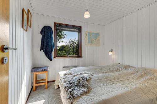 a bedroom with a bed and a window at C11603-Norre-Nebel-Marskvej-24 in Nørre Nebel