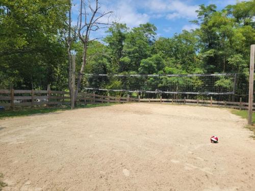 a soccer ball on a dirt field in front of a fence at Turkey Hollow with a one of a kind view in Bryant