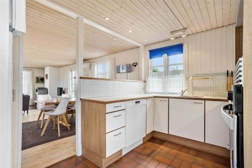 a kitchen with white cabinets and a table in a room at SJ243-Haderslev-Vikaerparken-79 in Haderslev