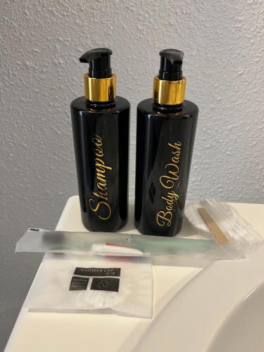 two black and gold bottles sitting on top of a table at L echappée d Opale - Jardin Privé et à 5 min de Ste Cécile Plage in Camiers