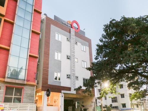 a building with a sign on the side of it at Hotel O IRA Sathyajyothi Comfort in Bengaluru