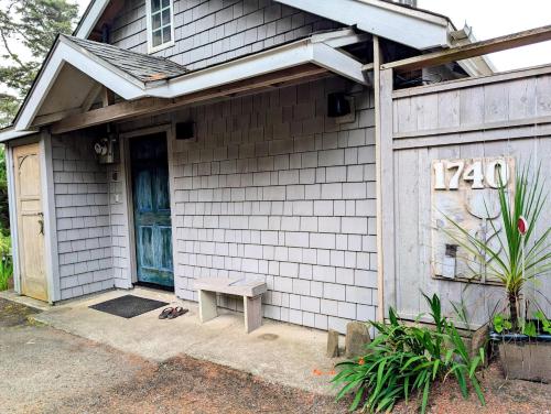 a house with a bench in front of a door at The Blue Door in Oceanside