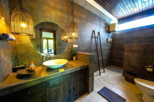 a bathroom with a sink and a mirror at Villa ABBI Luxury 2 Bedroom Villa - Legian Seminyak in Seminyak