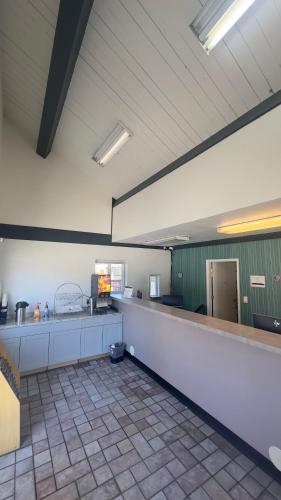 a kitchen with a long counter in a room at Super 8 by Wyndham San Jose Airport in San Jose