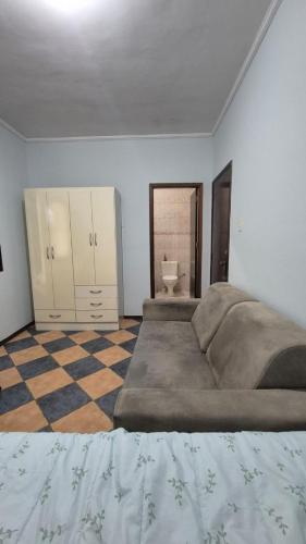 a large bedroom with a large bed and a toilet at Suíte319 in São José dos Campos