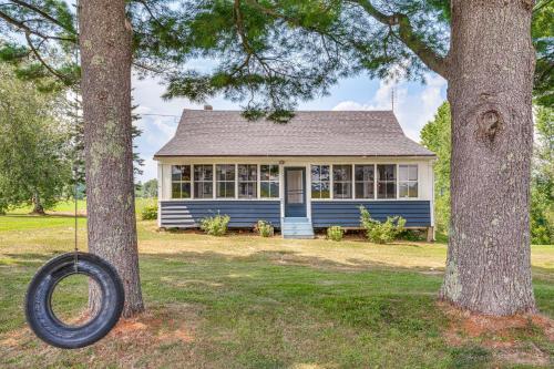 a blue house with a tire hanging between two trees at Less Than 1 Mi to Lake Mtn-View Cabin with Porch in Newport in Newport