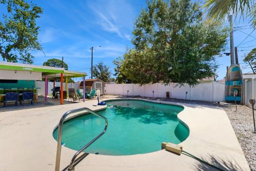 a swimming pool in the middle of a yard at Pinellas Park Cottage in St. Petersburg