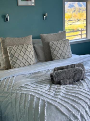a bed with two towels on top of it at Glacier Lake House in Tatare