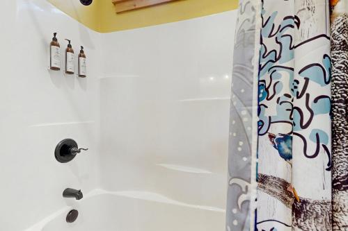 a bathroom with a shower with a shower curtain at Kat'z Place in Neskowin