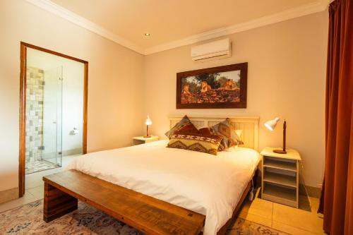 a bedroom with a bed and a mirror at Wolfkop Nature Reserve in Citrusdal