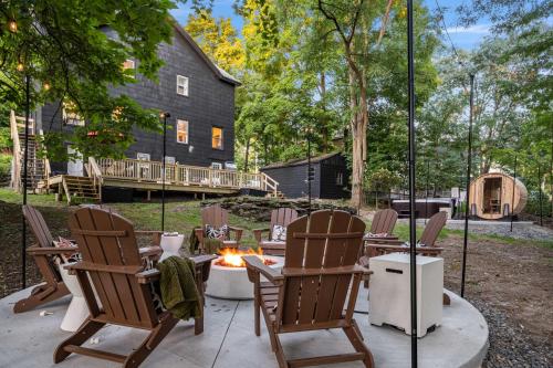 a patio with chairs and a fire pit in front of a house at Hudson Valley Hot Tub Sauna Fire Pit Games in Hudson
