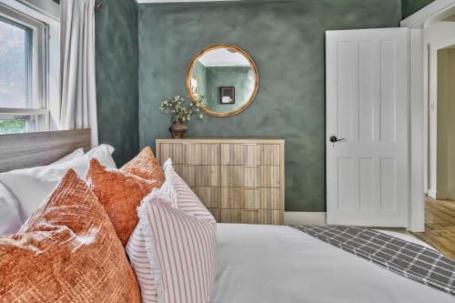 a bedroom with a bed with a mirror on the wall at Hudson Valley Hot Tub Sauna Fire Pit Games in Hudson