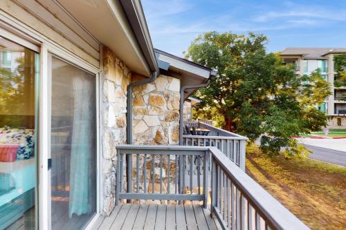 a balcony of a home with a stone wall at The Cove at Horseshoe Bay in Horseshoe Bay