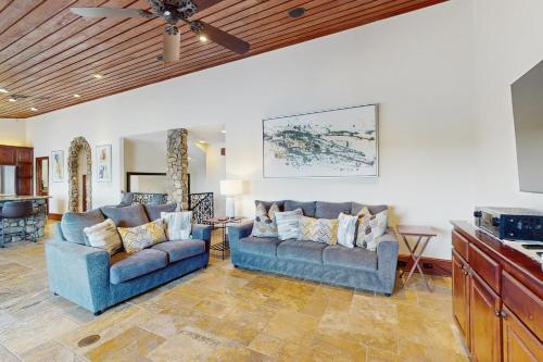 a living room with two couches and a table at Harbor Point in Spicewood