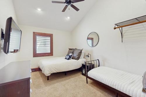 a bedroom with two beds and a ceiling fan at Harbor Point in Spicewood