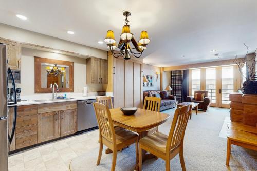 a kitchen and living room with a wooden table and chairs at Shoshone 1930 in Big Sky